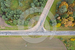 Aerial top down view of road interchange or intersection with single car driving