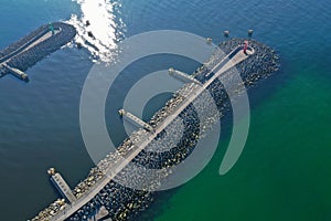 Aerial top down view on sea breakwaters and ship port entrance
