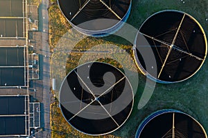 Aerial top down view of sewage treatment plant. Industrial water treatment with round water tanks for sewage recycling