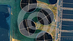 Aerial top down view of sewage treatment plant. Industrial water treatment with round water tanks for sewage recycling