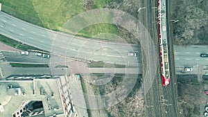 Aerial top down view shot involving car road traffic and moving train