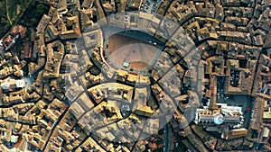 Aerial top-down view of Siena involving Piazza del Campo or Campo Square, a place of famous horse-race, Palio di Siena