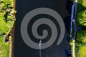 Aerial top down view on a small boat on a river. Transportation industry and sport