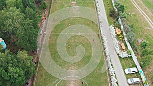 Aerial top down view of soccer field. Non-professional amateur football match. Drone shooting