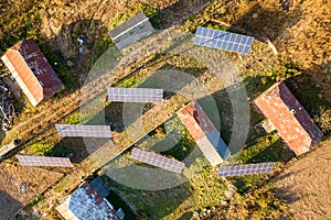 Aerial top down view of solar photo voltaic panels in green rural area. Clean renewable energy in private village environment