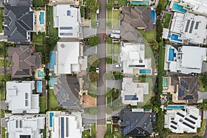 Aerial top down view of an upmarket suburban street lined with modern prestige homes, Australia