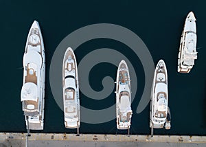 Aerial top down view of white yachts and boats moored in harbor pier