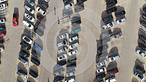 Aerial top down wide view of car moving and standing on parking lot
