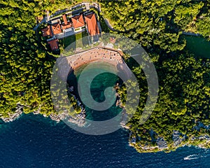 Aerial top shot of Queens beach with the resort and forest view, seascape around