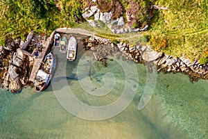 Aerial top view of the Atlantic Ocean and the shore in Donegal Ireland with docked ships