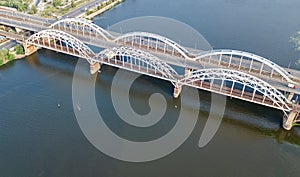 Aerial top view of automobile and railroad Darnitsky bridge across Dnieper river from above, Kiev Kyiv city skyline, Ukraine