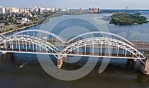 Aerial top view of automobile and railroad Darnitsky bridge across Dnieper river from above, Kiev Kyiv city, Ukraine