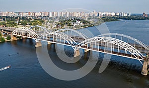 Aerial top view of automobile and railroad Darnitsky bridge across Dnieper river from above, Kiev Kyiv city, Ukraine