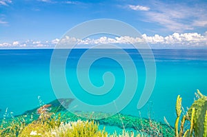 Aerial top view of beautiful amazing Tyrrhenian sea with turquoise water, tropical seascape, endless horizon with bright blue sky