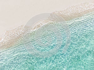 Aerial top view of beautiful tropical white sand beach with wave foam and transparent sea, Summer vacation and Travel