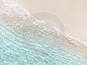 Aerial top view of beautiful tropical white sand beach with wave foam and transparent sea, Summer vacation and Travel background