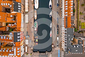 Aerial top view of boats in a canal and roofs of the buildings of Copenhagen in Denmark