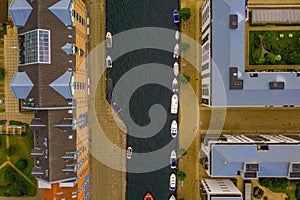Aerial top view of boats in a canal and roofs of the buildings of Copenhagen in Denmark