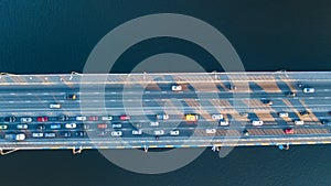 Aerial top view of bridge road automobile traffic jam of many cars from above, city transportation