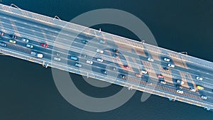Aerial top view of bridge road automobile traffic jam of many cars from above, city transportation concept