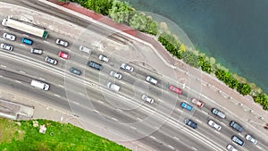 Aerial top view of bridge road automobile traffic jam of many cars from above, city transportation concept
