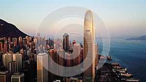 AERIAL. Top view of buildings in Hong Kong city at sunset.