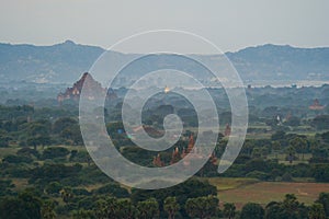 Aerial top view of burmese temples of Bagan City from a balloon, unesco world heritage with forest trees, Myanmar or Burma.