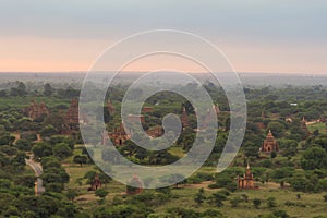 Aerial top view of burmese temples of Bagan City from a balloon, unesco world heritage with forest trees, Myanmar or Burma.