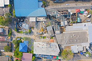 Aerial top view of busy industrial factory or plant. Construction site workers with cranes working. Top view of development high