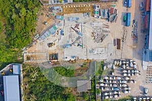 Aerial top view of busy industrial factory or plant. Construction site workers with cranes working. Top view of development high