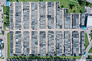 Aerial top view of car garages in urban area