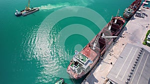 Aerial top view of cargo ship carrying container.Container ship loading and unloading in deep sea port, Aerial view of business lo