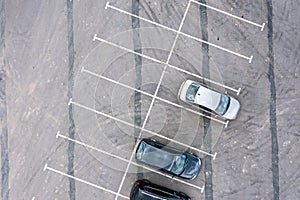 Aerial top view of cars standing on a parking lot