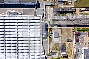Aerial top view of city industrial area and roof of modern plant