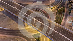 Aerial top view city traffic on elevated crossroad in Dubai Business bay night timelapse.