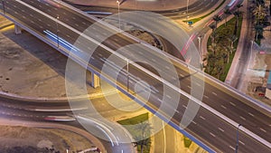 Aerial top view city traffic on elevated crossroad in Dubai Business bay night timelapse.