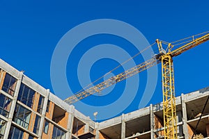 Aerial top view of construction site new multi-storey buildings tower crane with unfinished high-rise building