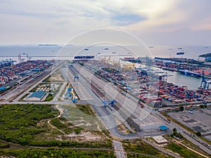 Aerial top view of container cargo ship in the export and import business and logistics international goods in urban city.