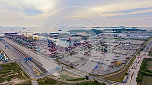 Aerial top view of container cargo ship in the export and import business and logistics international goods in urban city.