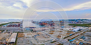 Aerial top view of container cargo ship in the export and import business and logistics international goods in urban city.