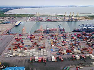 Aerial top view of container cargo ship in the export and import business and logistics international goods in urban city.