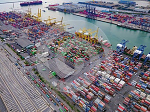 Aerial top view of container cargo ship in the export and import business and logistics international goods in urban city.