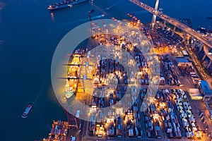 Aerial top view of container cargo ship in the export and import business and logistics international goods in urban city.