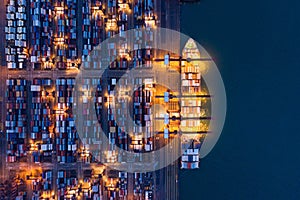 Aerial top view of container cargo ship in the export and import business and logistics international goods in urban city.