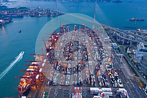 Aerial top view of container cargo ship in the export and import business and logistics international goods in urban city.