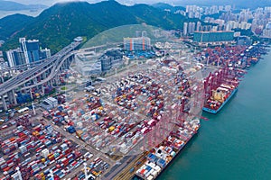 Aerial top view of container cargo ship in the export and import business and logistics international goods in urban city.