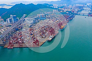 Aerial top view of container cargo ship in the export and import business and logistics international goods in urban city.