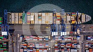 Aerial top view container cargo ship unloading in import export business logistic and transportation of international by container