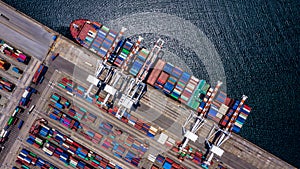 Aerial top view container cargo ship unloading in import export business logistic and transportation of international by container