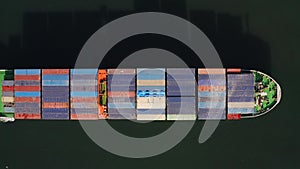 Aerial: top view of a container ship with a cargo of container